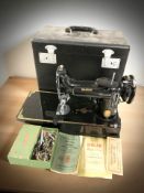 A Singer featherweight sewing machine in box.