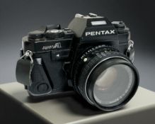 A Pentax Super A 35mm film camera with SMC Pentax-M 1:2 50mm lens.