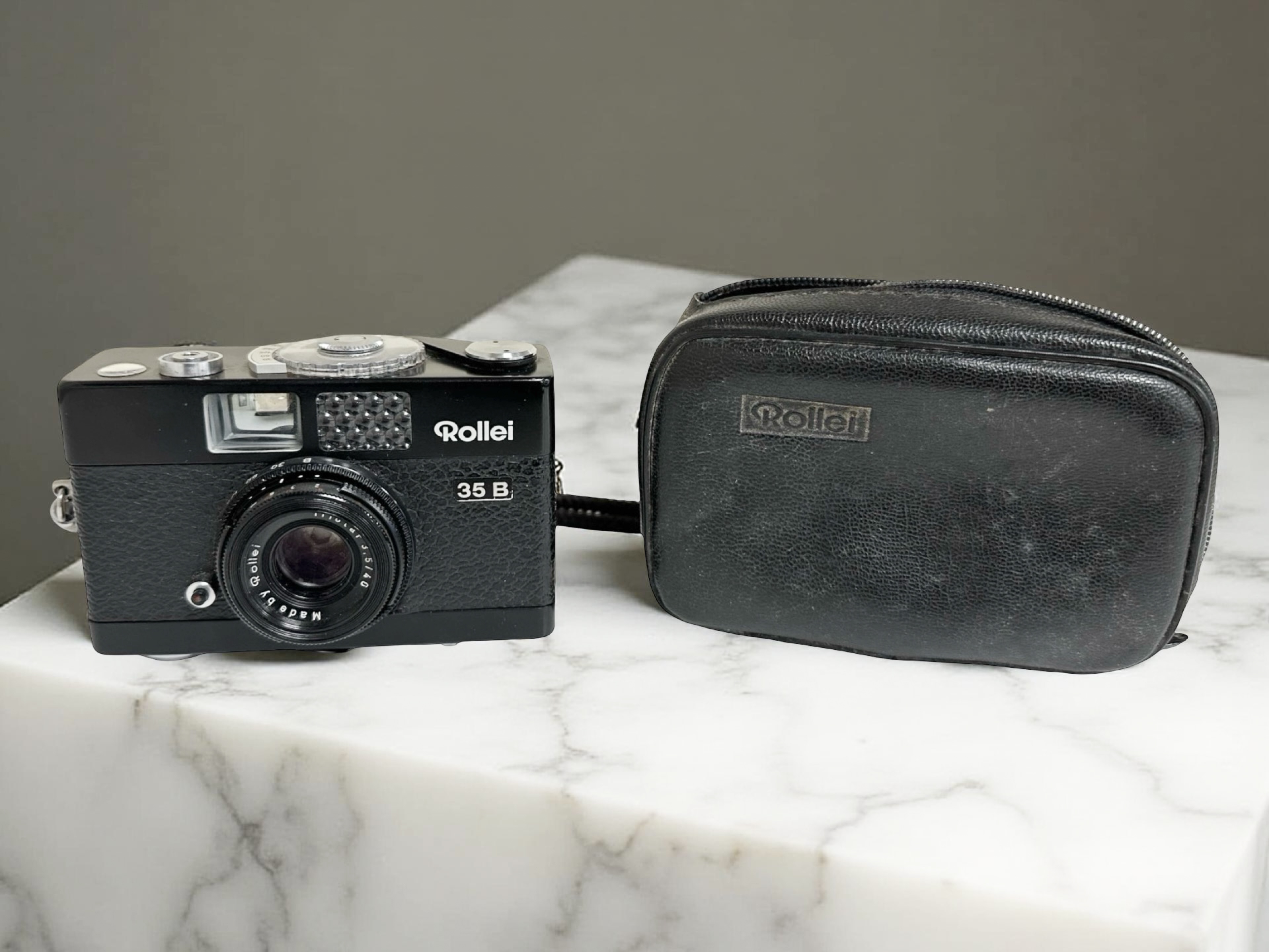 A Rollei 35B 35mm film camera with Triotar 3,5/40mm lens, in fitted leather pouch.