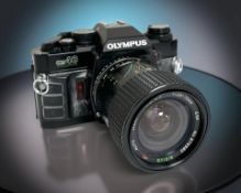An Olmpus OM40 Program 35mm film camera with Sirius MC Auto Zoom 1:3.5-4.5 f=28-70mm lens.
