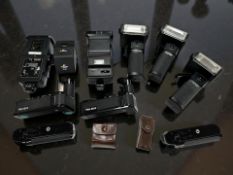 A collection of vintage flash guns / accessories to include three Hanimex Pro 550 examples,