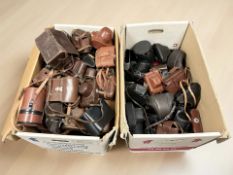 A large quantity of vintage film camera cases, mostly for 35mm cameras.