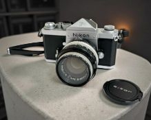 A Nikon F 35mm film camera with Nikkor-S Auto 1:1.4 f=50mm lens and Vivitar 1A skylight lens filter.