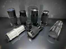 A collection of vintage zoom / telephoto lenses to include R. Topcor 1:5.