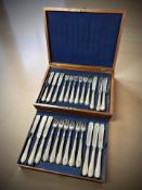 A walnut canteen of a twelve place setting EPNS fish cutlery service.