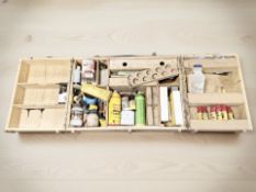 A folding wooden carpenter's box containing assorted products.