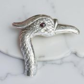 An antique continental silver parasol or walking stick handle in the form of a bird's head,