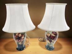 A pair of Moorcroft Hibiscus table lamps, with shades, overall height 47 cm.