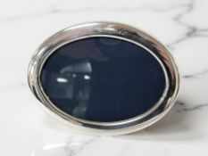 An oval silver easel photo frame, Sheffield 1990, width 16.5cm.