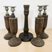 A set of four turned wooden candlesticks, plus one other similar, height 31 cm.