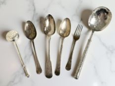An 18th century silver dessert spoon, together with two further antique silver spoons,
