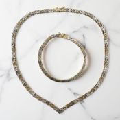 A two-tone silver necklace and matching bracelet CONDITION REPORT: 37.