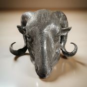 A reproduction patinated metal ram's head wall hanging, depth from the wall 15 cm.