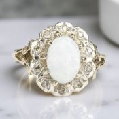 A 9ct gold opal and diamond cluster ring,