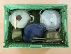 A group of Le Creuset enameled cast iron pans.