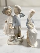 A Lladro figure group of a boy and girl holding hands,