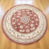 A machine made circular woolen rug of Iranian design,