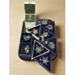 A group of Swarovski crystal Christmas tree decorations, including snowflakes,