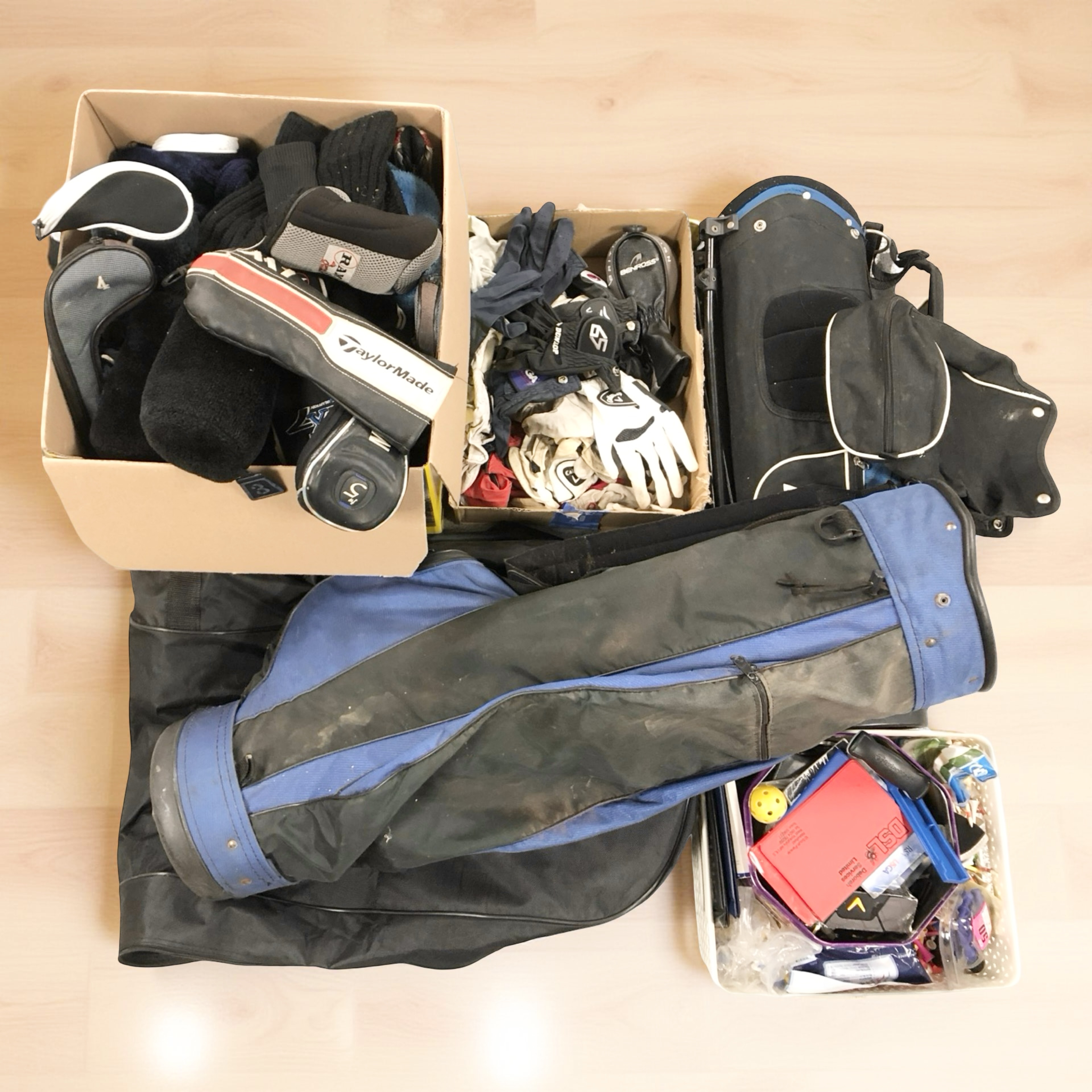 A group of gold bags, golf club head covers,