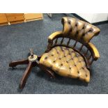 A Chesterfield style Oxblood tan leather captain's swivel armchair (as found)