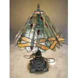 A Tiffany-style patinated metal and stained glass dragonfly table lamp, height 55 cm.