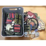 A collection of military cloth badges and insignia.
