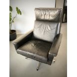 A Scandinavian black leather armchair on chrome legs