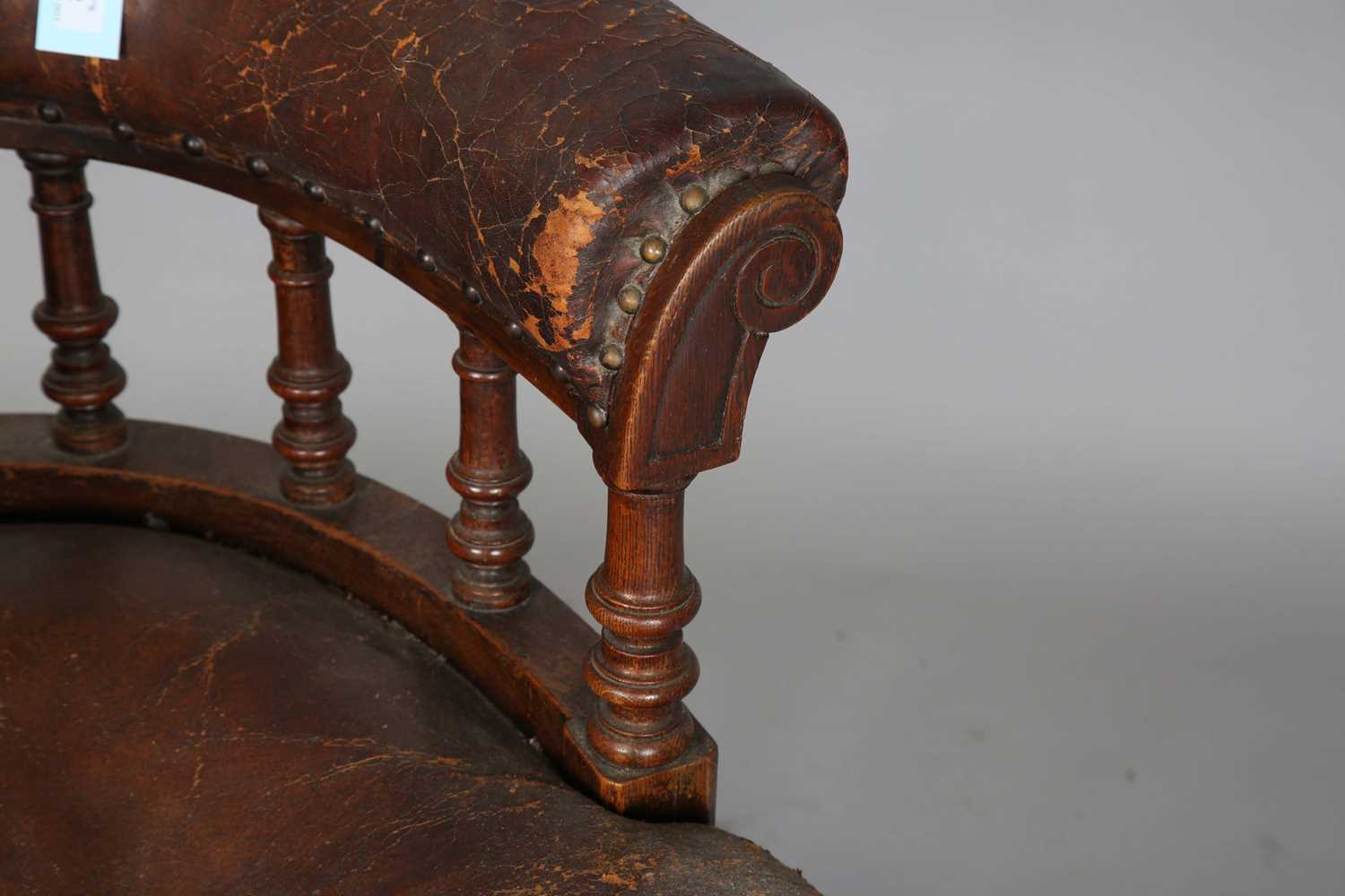 A late Victorian oak framed tub back desk chair, upholstered in brown leather, height 74cm, width - Image 3 of 11