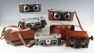 A collection of assorted cameras and lenses, including a Zeiss Ikon Ikonta 521/16 camera, leather