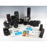 A collection of Minolta cameras and lenses, including an Autocord twin lens reflex camera with