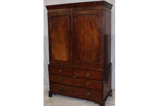 A 19th century mahogany linen press with two short and three long drawers below a recess enclosed - Image 1 of 3