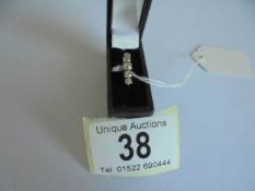 A 18ct gold five stone diamond ring, size N, 2.6 grams.