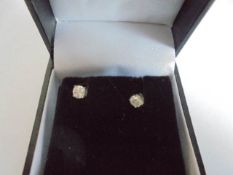 A pair of 9ct gold 20pt diamond studs.