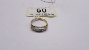 An 18ct gold and platinum diamond ring, size M half, 3 grams.