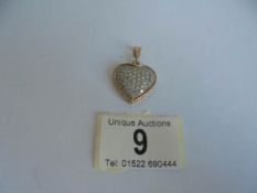 An approximately 3 carat diamond heart set in two tone gold, 7.19 grams.