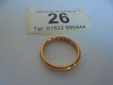 A 22ct gold wedding ring, size J, 5 grams.