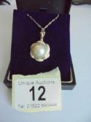 A 14ct gold diamond and pearl pendant on a 14ct gold chain, 7.69 grams.