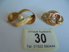A 9ct gold brooch (3.48 grams) and a yellow metal brooch.