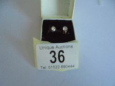A pair of 9ct gold and diamond stud earrings.