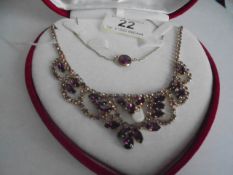 A good quality necklace and pendant set amethyst coloured stones.