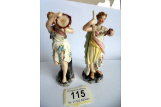 A pair of 19th century continental porcelain musician figurines. - Image 1 of 4