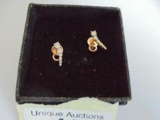 A pair of 18ct gold and diamond graduated earrings. 1.64 grams