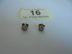 A pair of white gold diamond stud earrings, 1.28 grams.