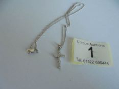 An 18ct white gold and diamond cross on an 18ct gold chain. 4.37 grams.
