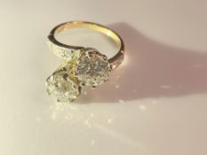 An 18ct gold ring set two x two carat diamonds, size O, total weight 7.4 grams.