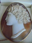 A finely carved shell cameo brooch with safety chain (a/f crack to left side).