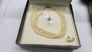 A triple strand pearl necklace with 18ct and diamond clasp with original receipt.