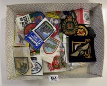 A quantity of cloth military badges & a quantity of tourist patches etc