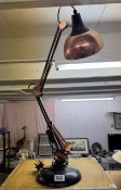 A copper coloured Anglepoise lamp