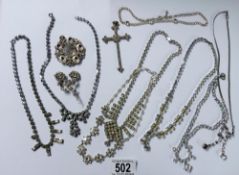 Eight pieces of diamonte' jewellery including cross pendant.